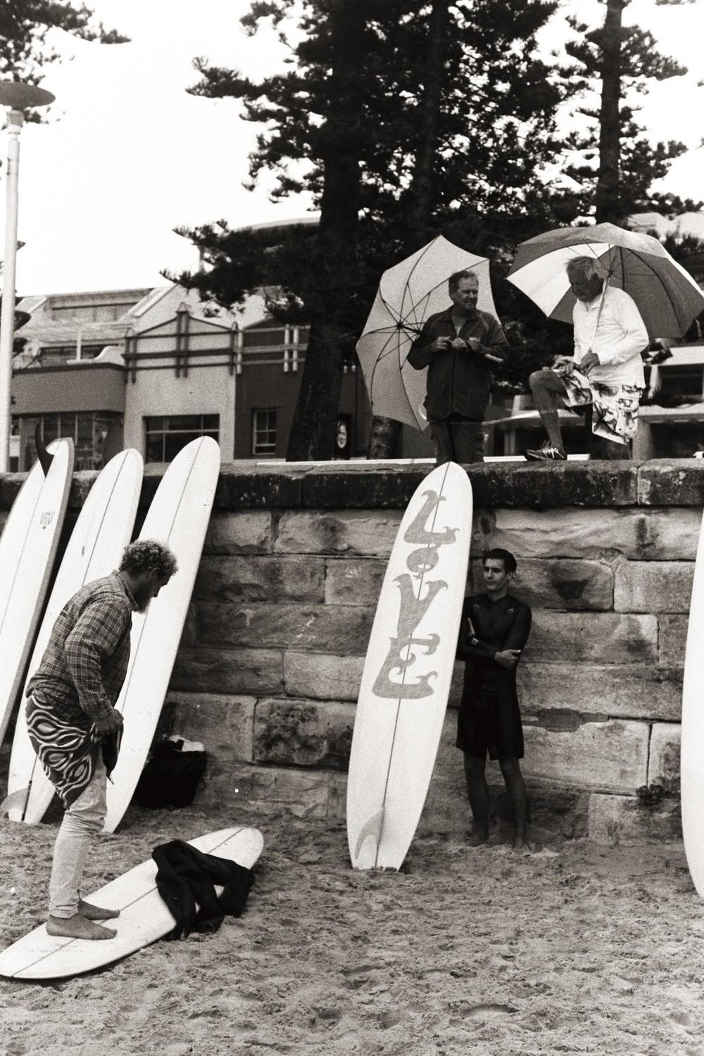 Myles Doughman getting into his wetsuit one freezing winter morning as the past generation stand above, reminiscing on the days they would done the same